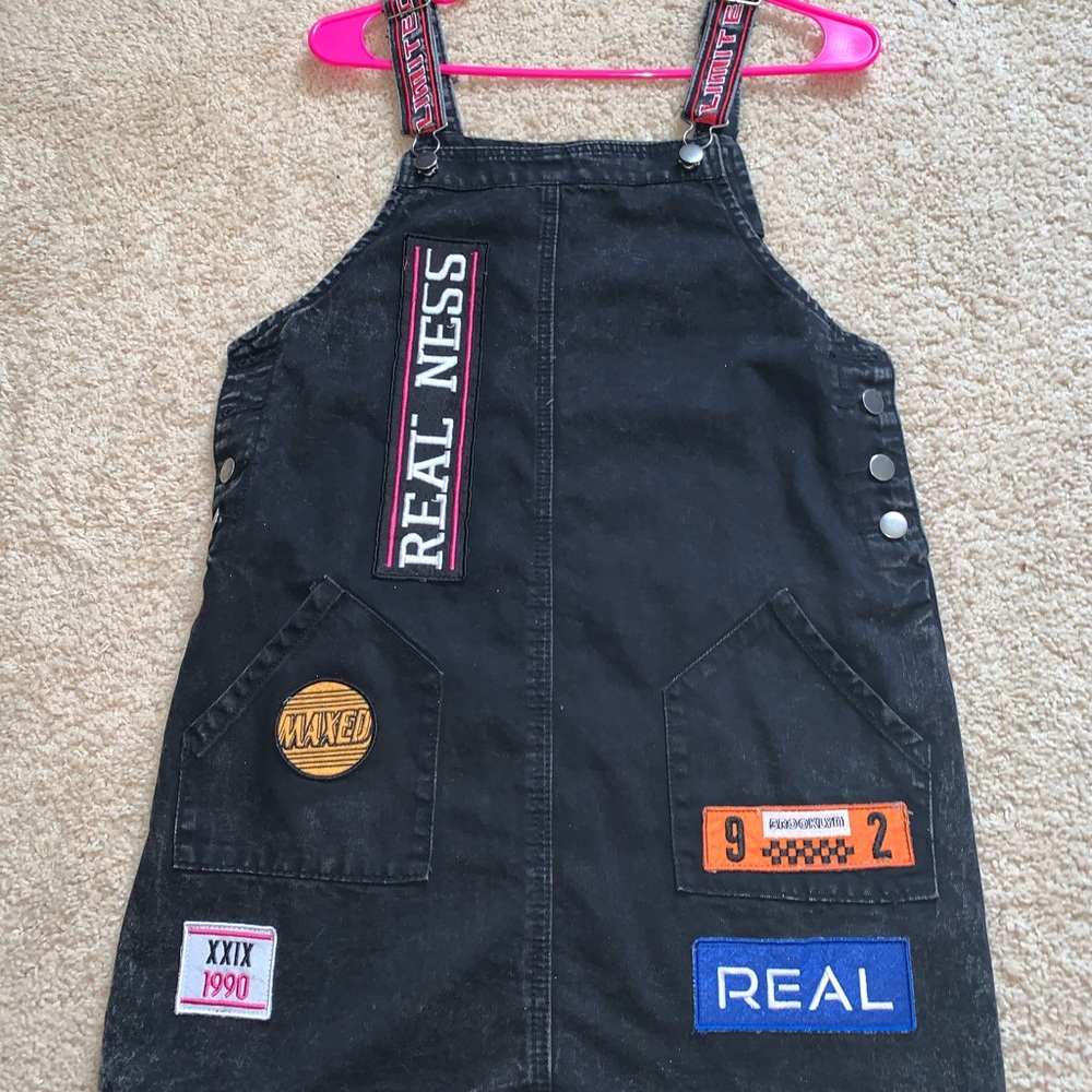 Black overalls with patches